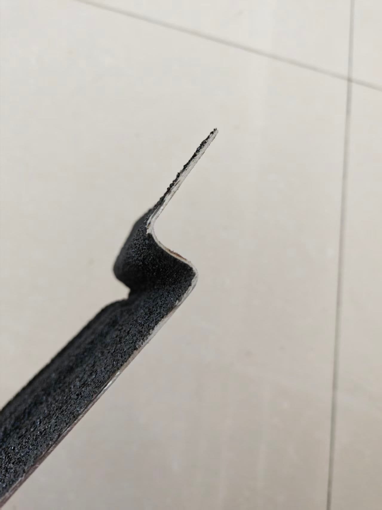 Poor quality tiles with sharp edges and burrs